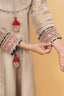 Beige Sharara Set adorned with elegant neck tassel details.